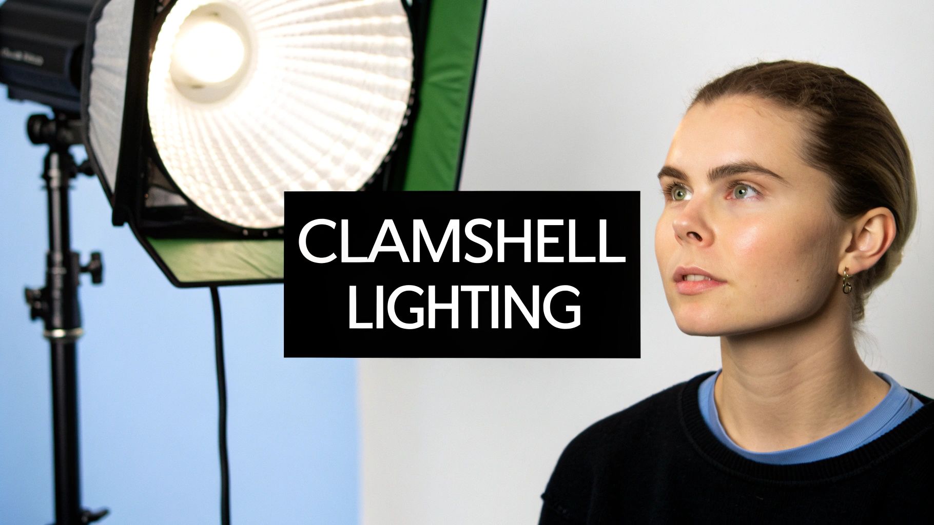 A woman next to a professional clamshell lighting setup for studio portrait photography.