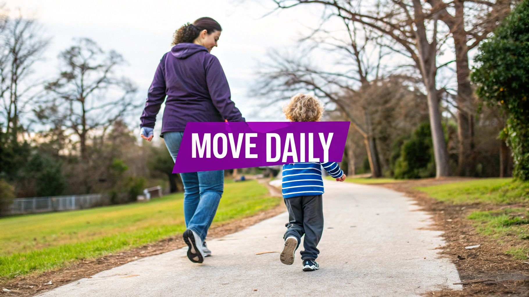 A parent and child walk hand-in-hand on a park path, promoting daily movement and activity.
