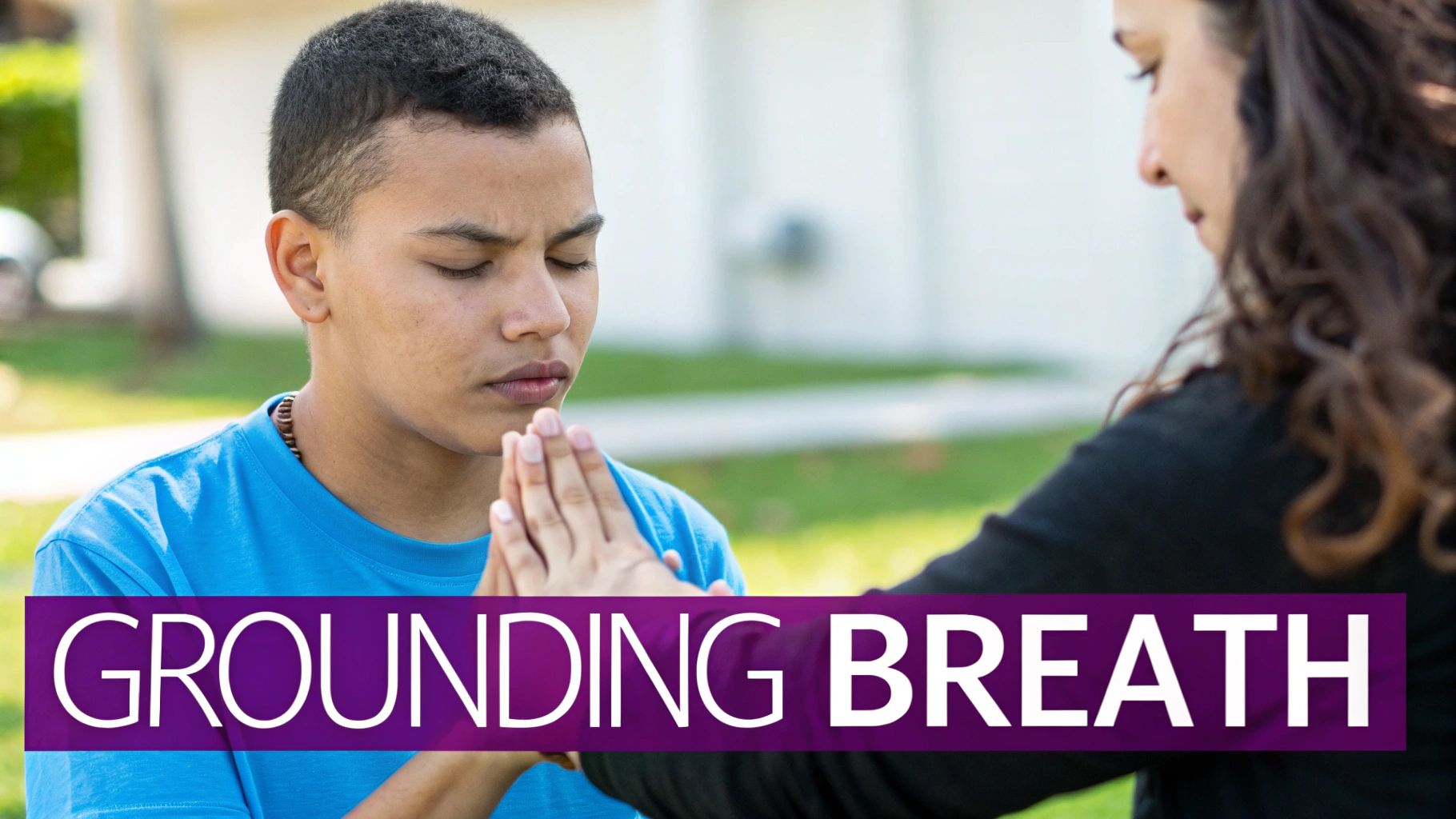 A young person practices "Grounding Breath" meditation with closed eyes and pressed hands, guided by another.