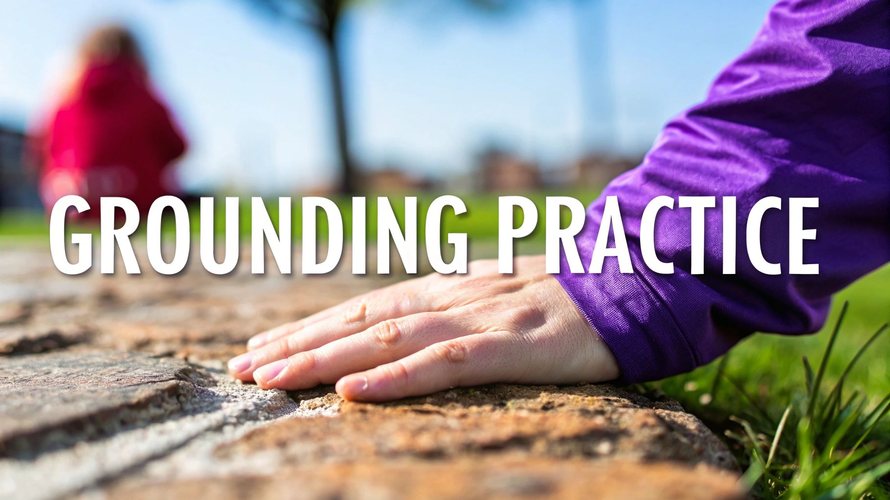 A hand in a purple sleeve touches rough ground with grass, illustrating a grounding practice.