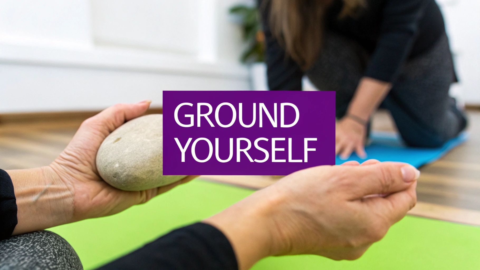 Hands hold a smooth grounding stone during a meditation or yoga session, with 'GROUND YOURSELF' text.