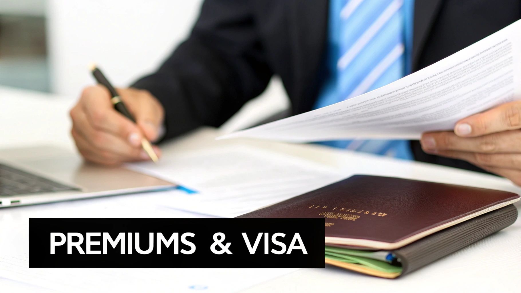 A businessperson signing forms with a pen, holding documents, next to a passport and laptop.