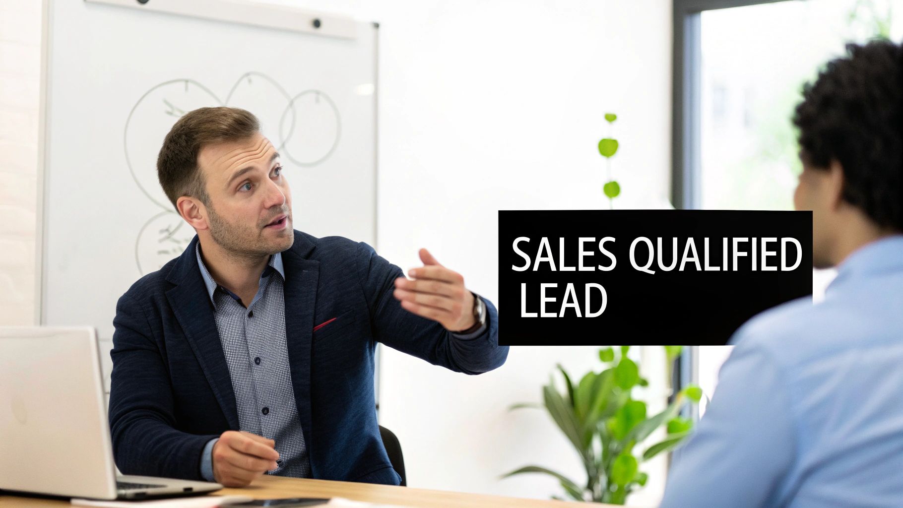 A man explains business concepts to a colleague, with a 'SALES QUALIFIED LEAD' overlay in an office.