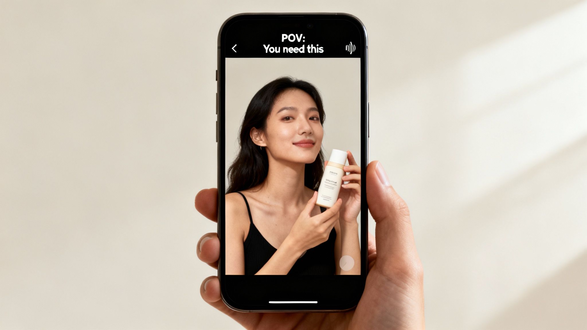 Hand holds a smartphone showing a beauty ad with a smiling woman holding a skincare product.