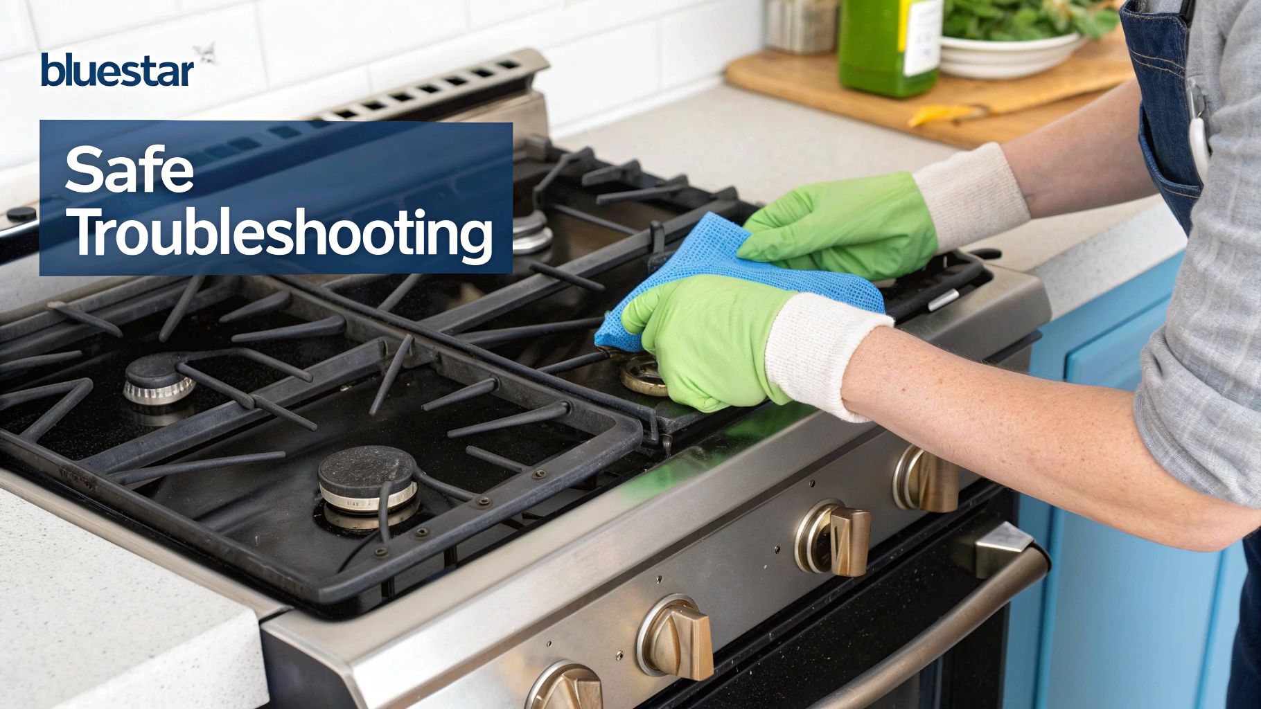 Person in green gloves safely cleaning a Bluestar gas range stovetop with a blue cloth.