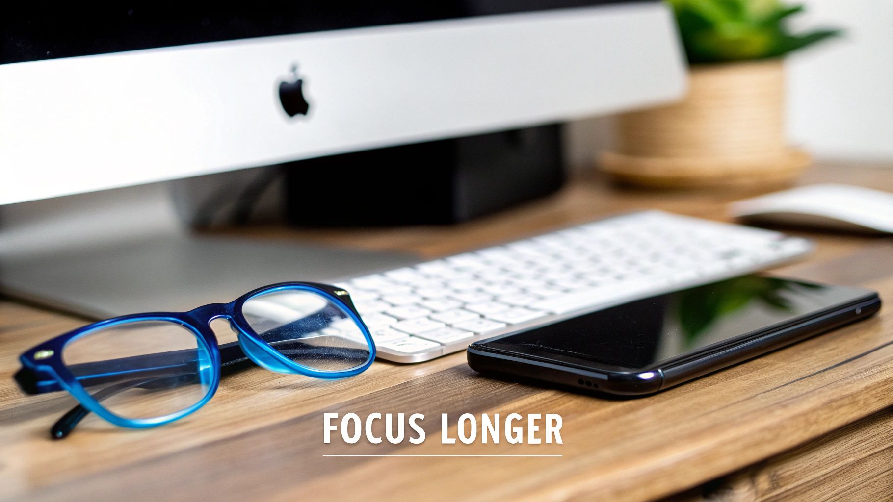 Element Lux blue light blocking glasses with orange lenses resting on an open book, with a laptop in the background.