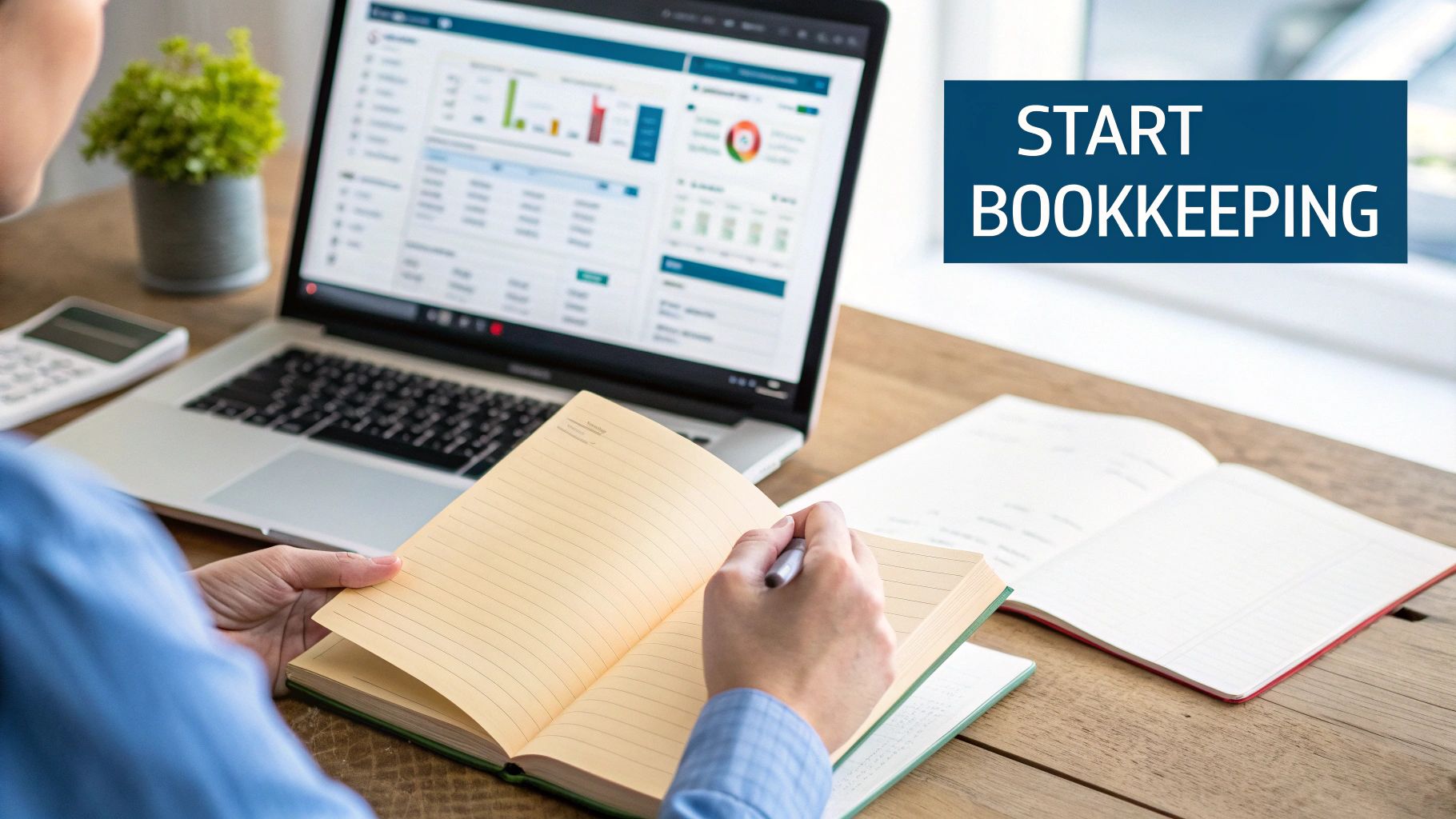 Over-the-shoulder view of a person using a laptop and notebook for bookkeeping tasks.