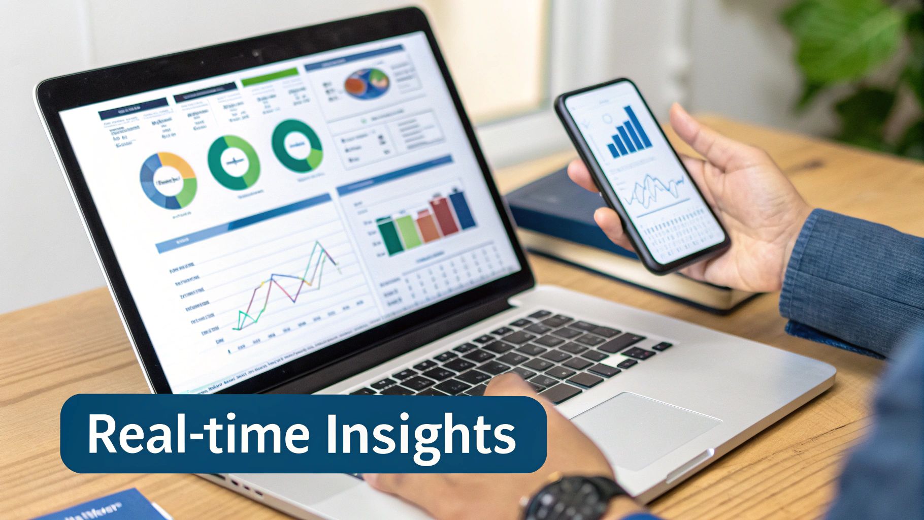 Person analyzing real-time business data with charts and graphs on a laptop and smartphone screens.