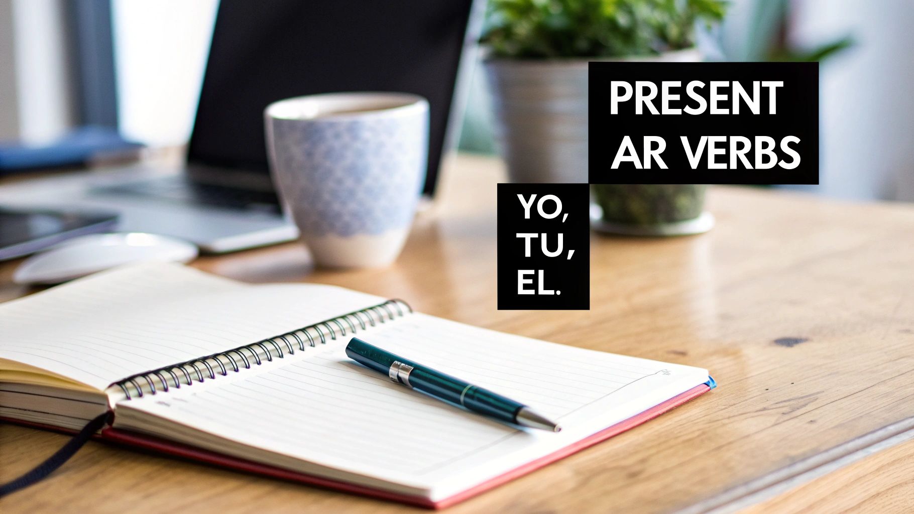 A desk with a laptop, notebook, pen, and text about Spanish present AR verbs and pronouns.