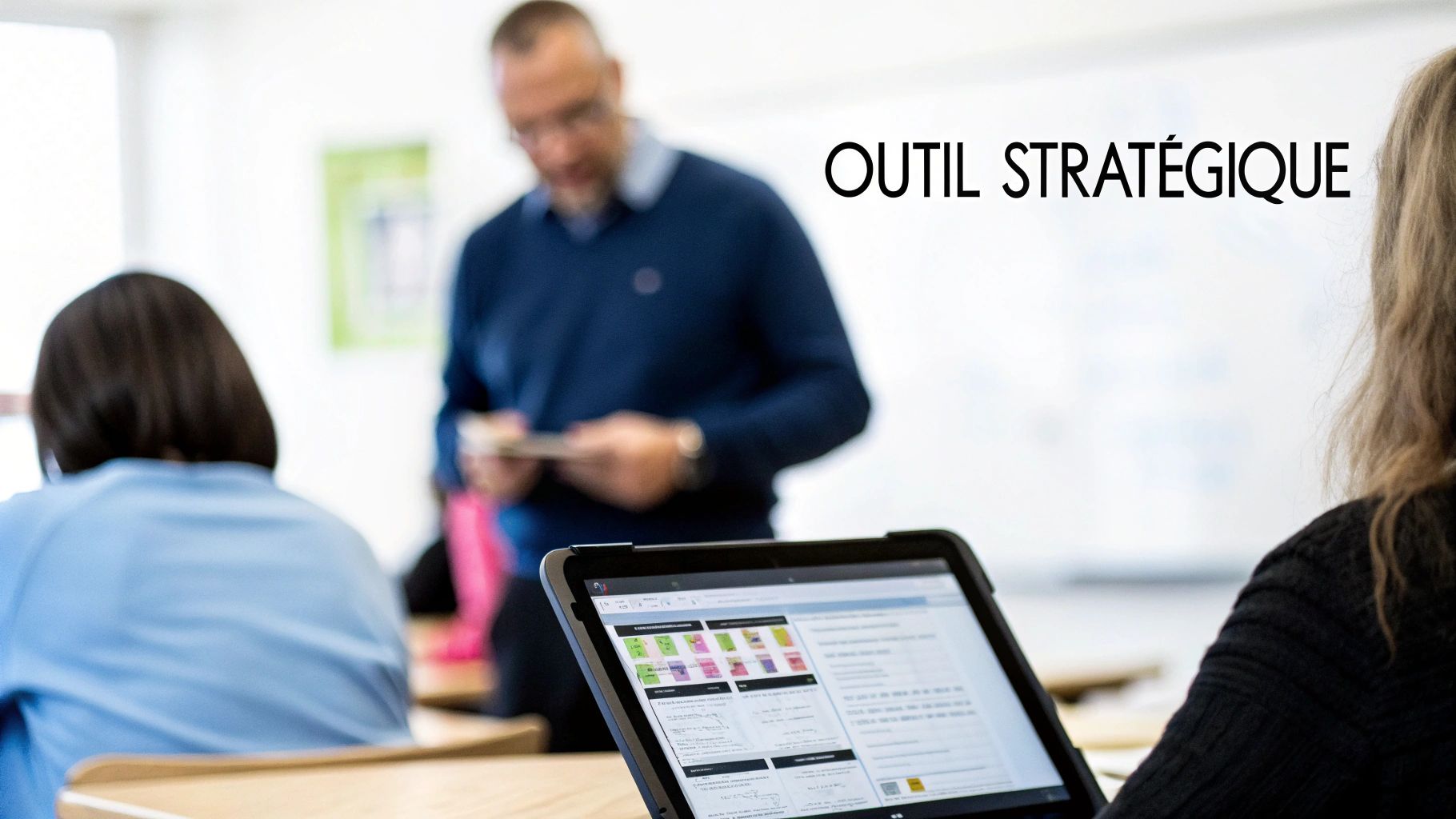 Une personne utilise une tablette affichant des informations dans un contexte de formation sur les outils stratégiques.
