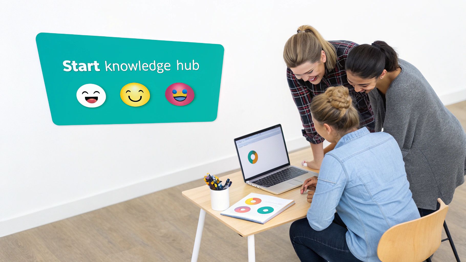 Three women collaborate at a desk with a laptop and documents; a sign says 'Start knowledge hub'.