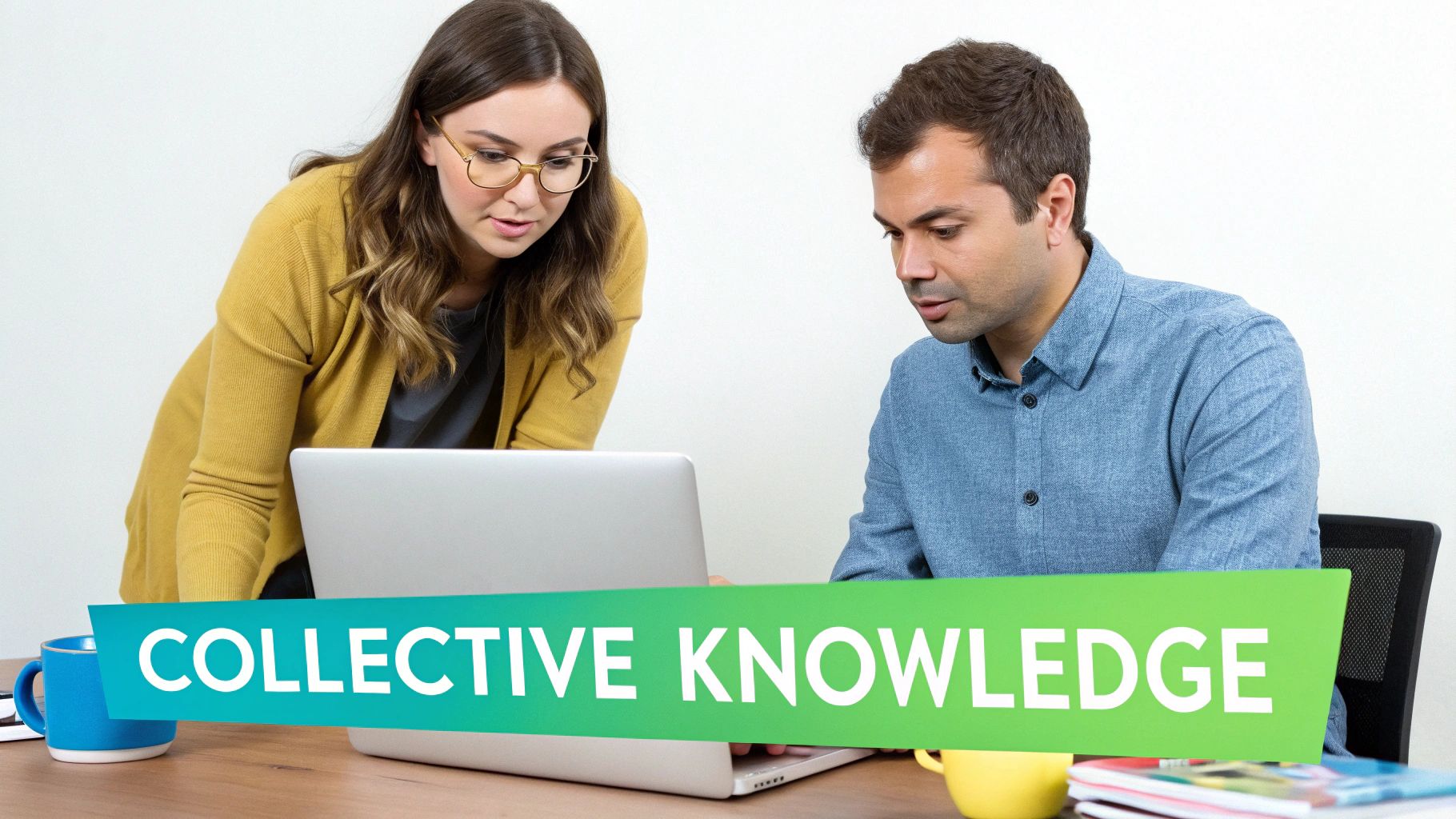 Two colleagues collaborate on a laptop, sharing collective knowledge at a modern workspace.