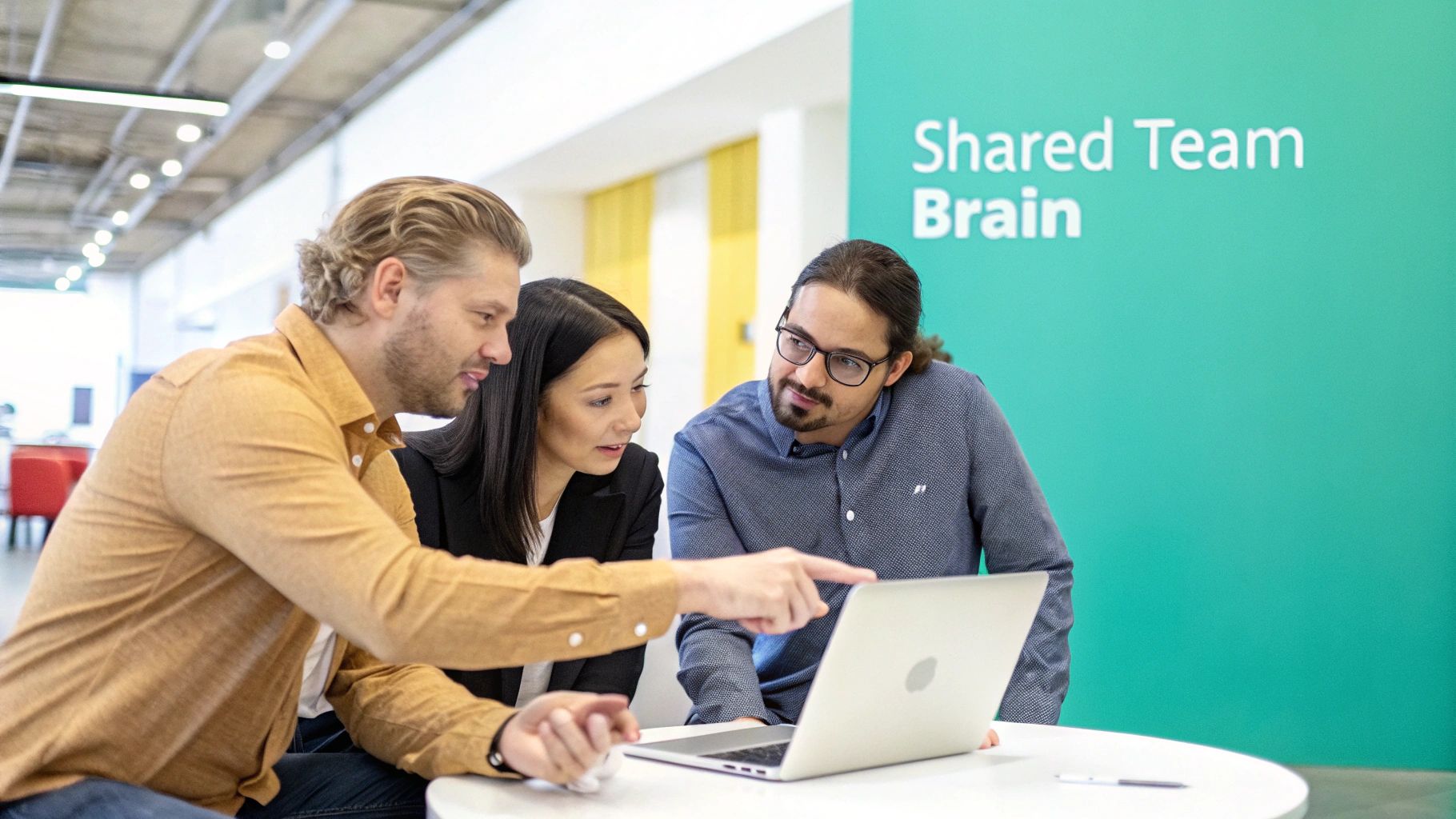 Three diverse professionals collaborate around a laptop in a modern office, sharing ideas and knowledge.