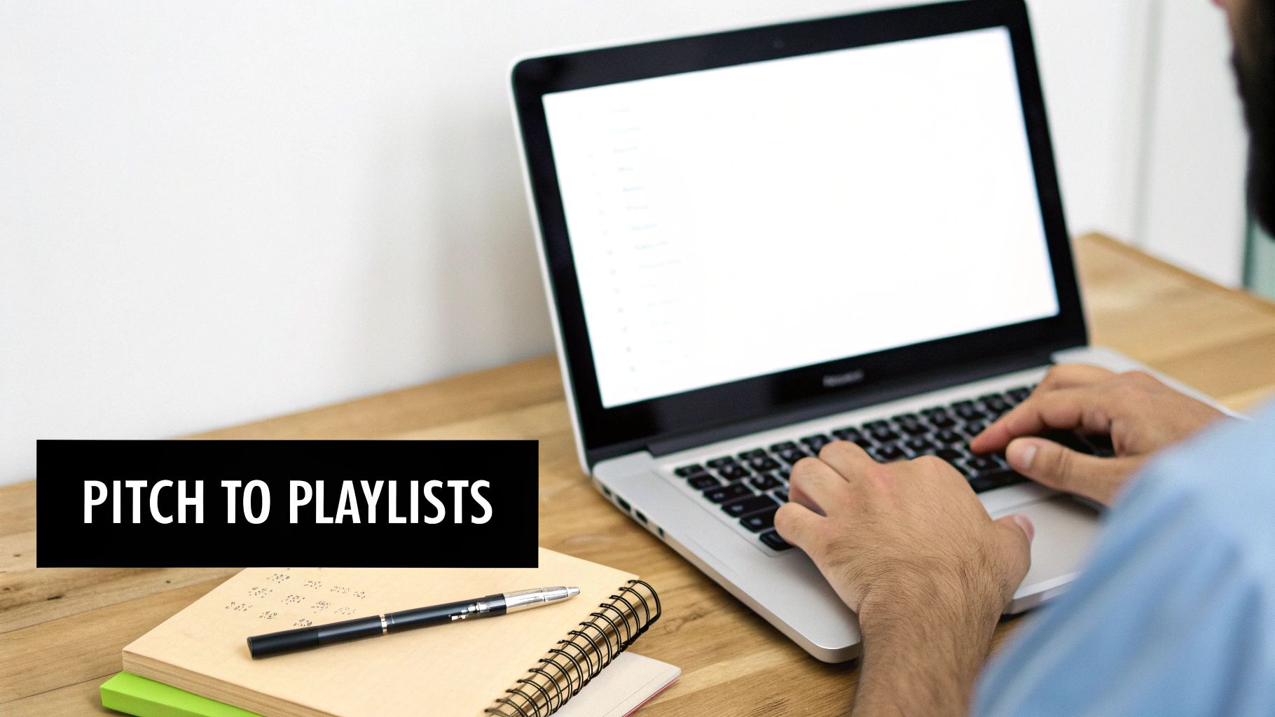 A person types on a laptop next to a notebook and pen, with a 'PITCH TO PLAYLISTS' text overlay.