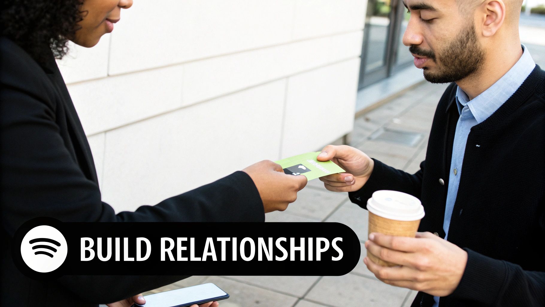 Two people exchanging a green business card, symbolizing networking and building relationships.