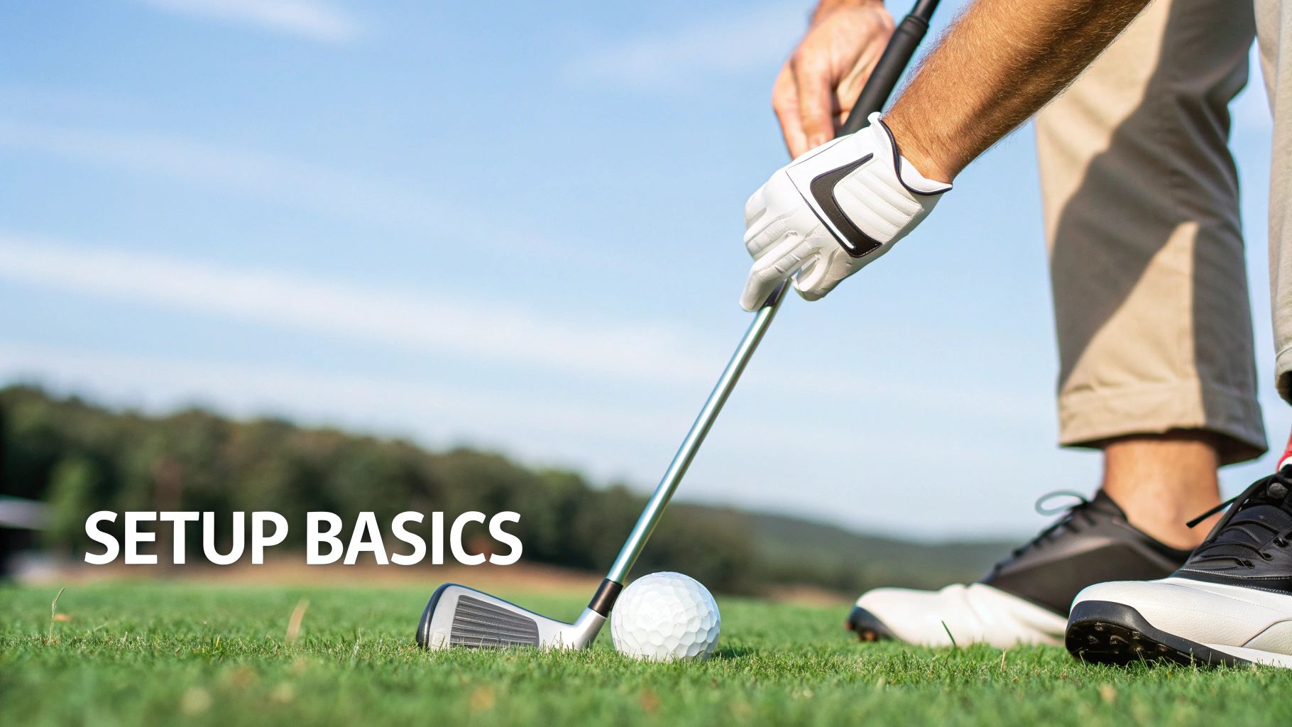 A golfer getting ready to hit an iron shot on a lush green course.