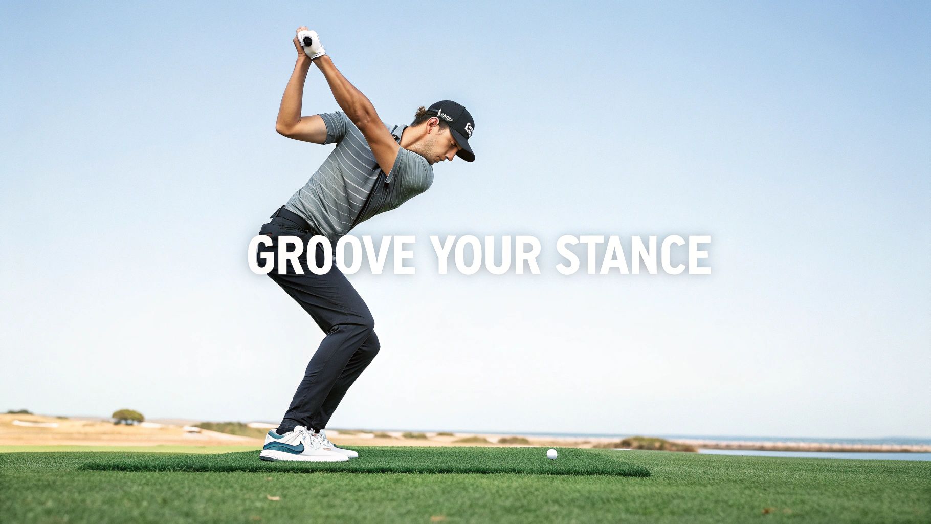 Professional golfer demonstrating proper stance and positioning during golf swing on coastal course