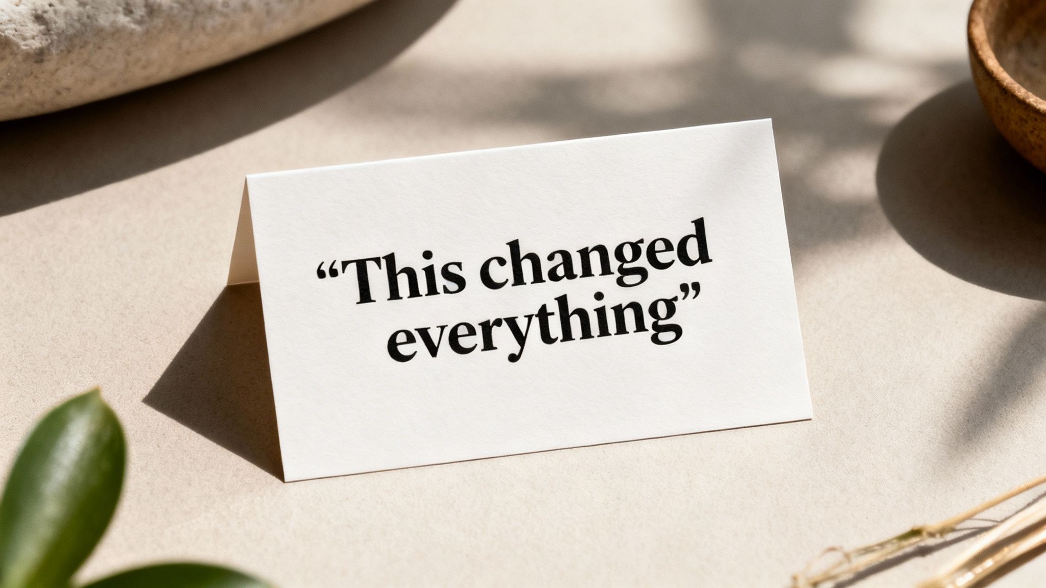 White folded card with the inspiring quote 'This changed everything' on a minimalist desk setting.