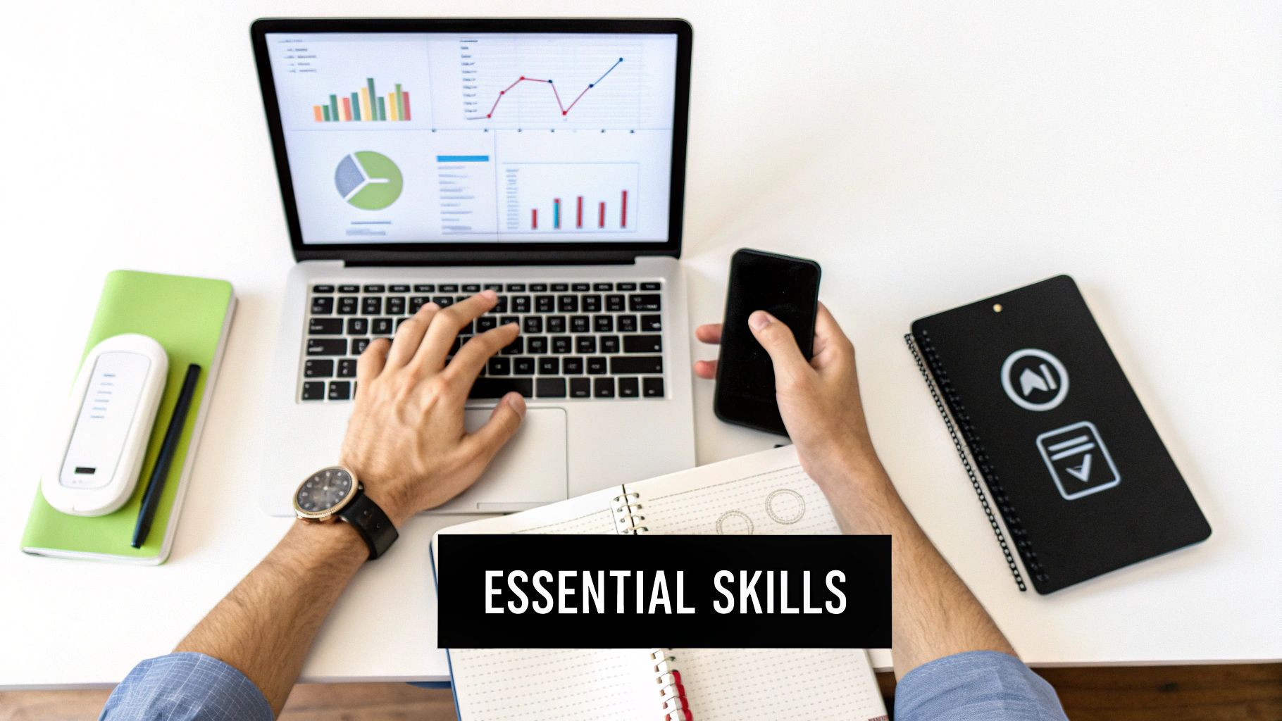 A person's hands work on a laptop displaying data, holding a phone, with 'ESSENTIAL SKILLS' text overlay.