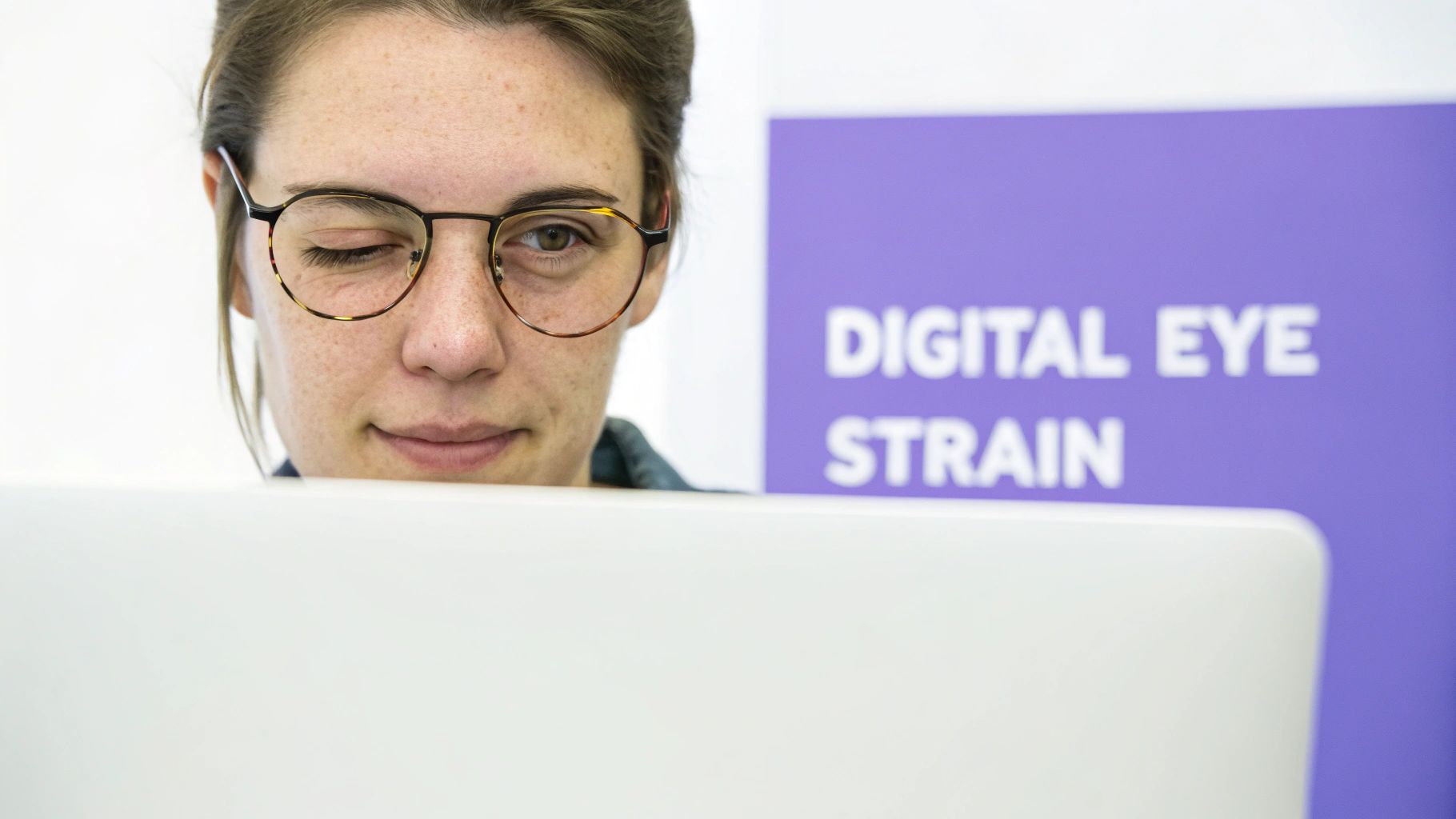 A person's tired eyes reflecting a computer screen, illustrating digital eye strain.