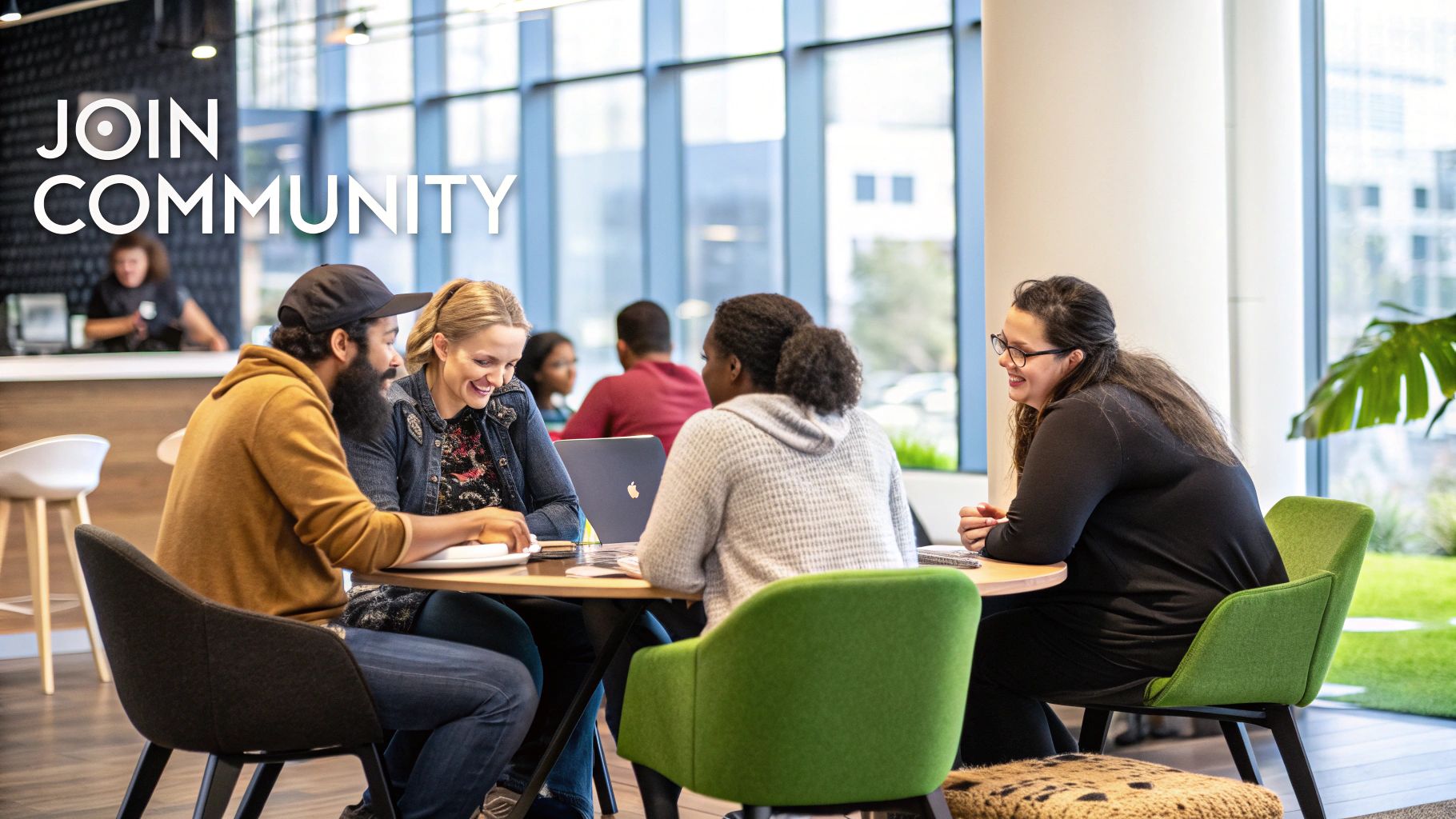 Four diverse individuals, smiling and engaged, work together at a table in a modern community space.