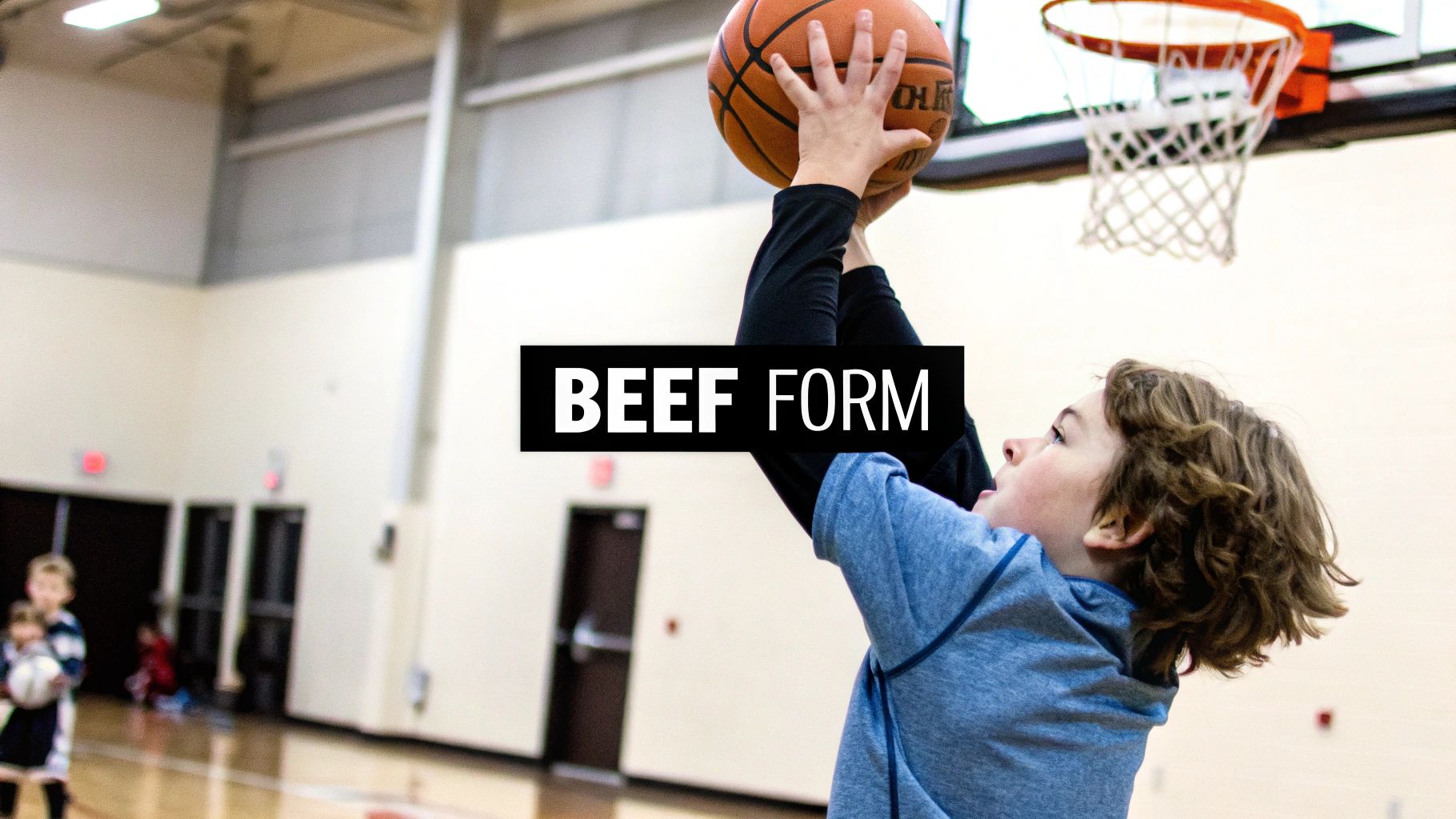 A young boy with curly hair practices shooting a basketball in a gym, focusing on proper form.