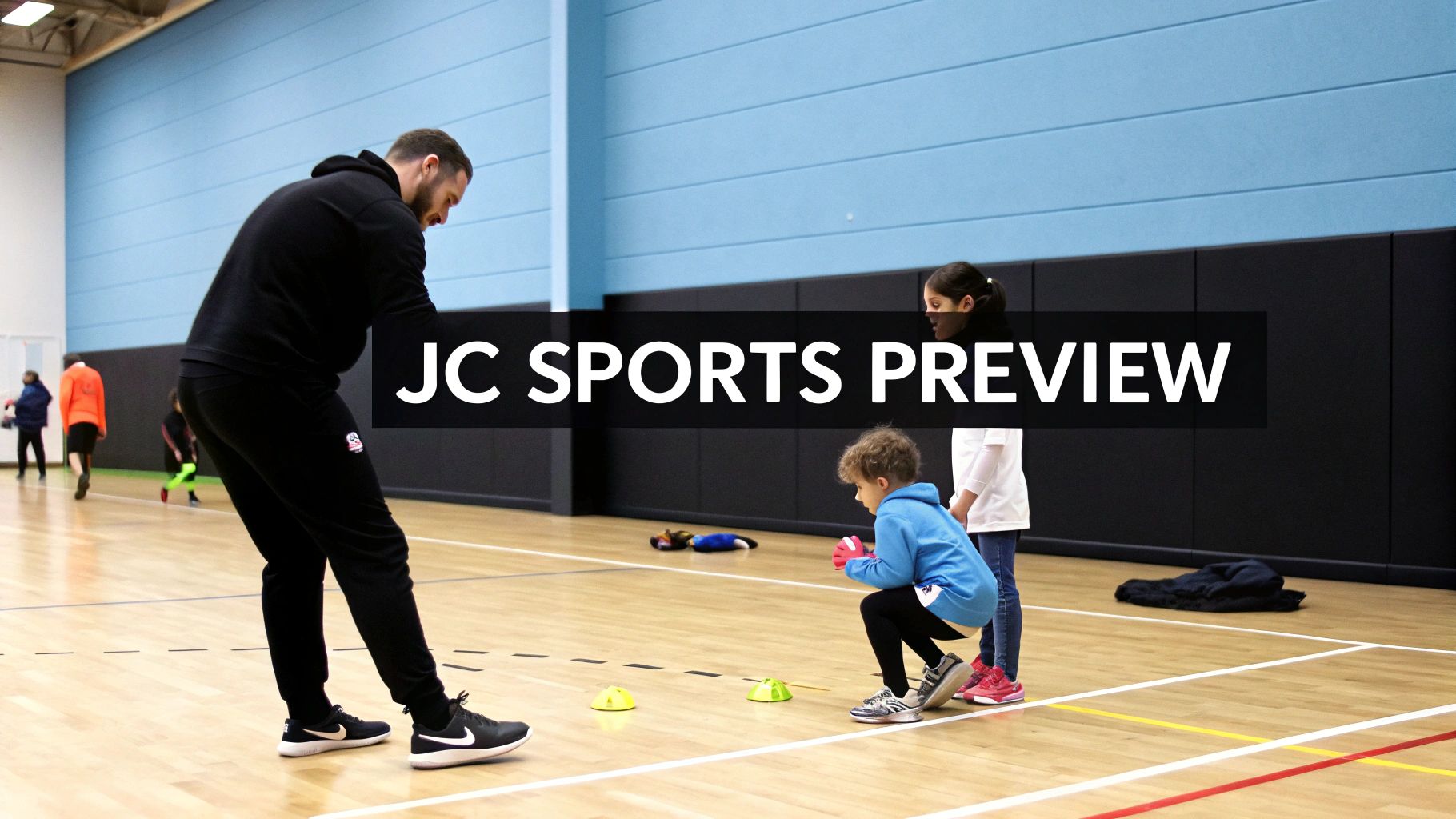 An adult coach supervises two children on a sports court during a youth training session with cones.