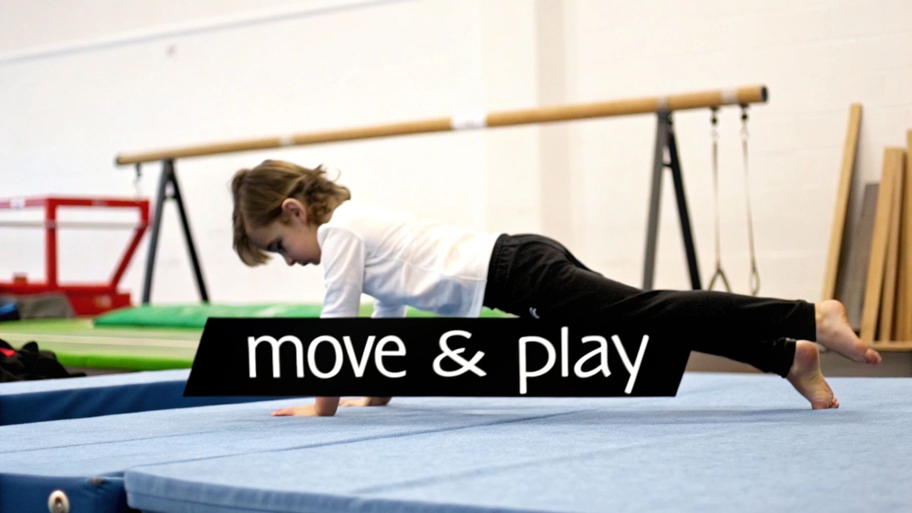 A young child performs a plank on a blue gymnastics mat in a gym, with text 'move &amp; play'.