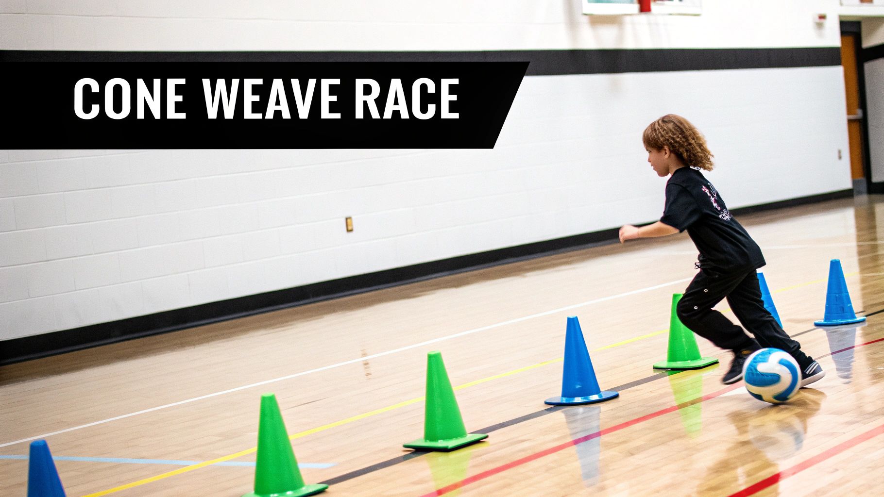 A child dribbles a soccer ball through blue and green cones on a gym floor, participating in a cone weave race.