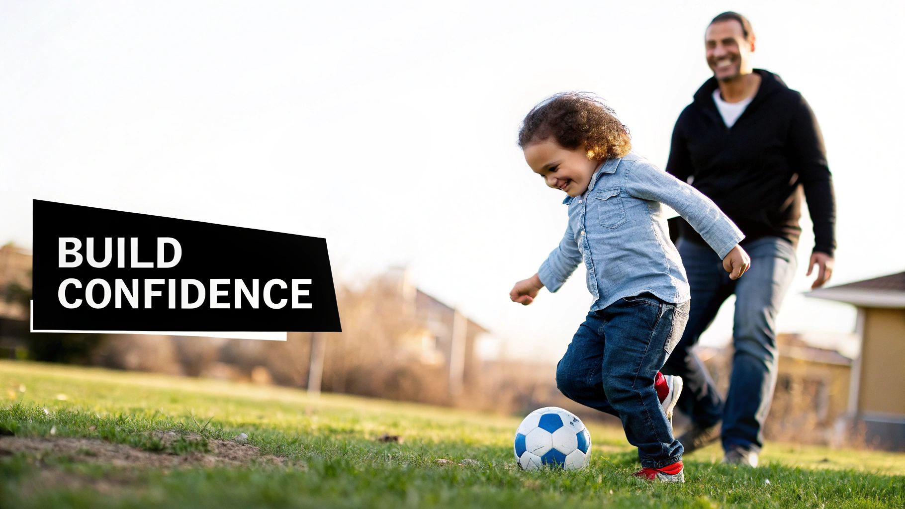 A happy preschooler plays soccer with an adult in a sunny grassy field, building confidence.