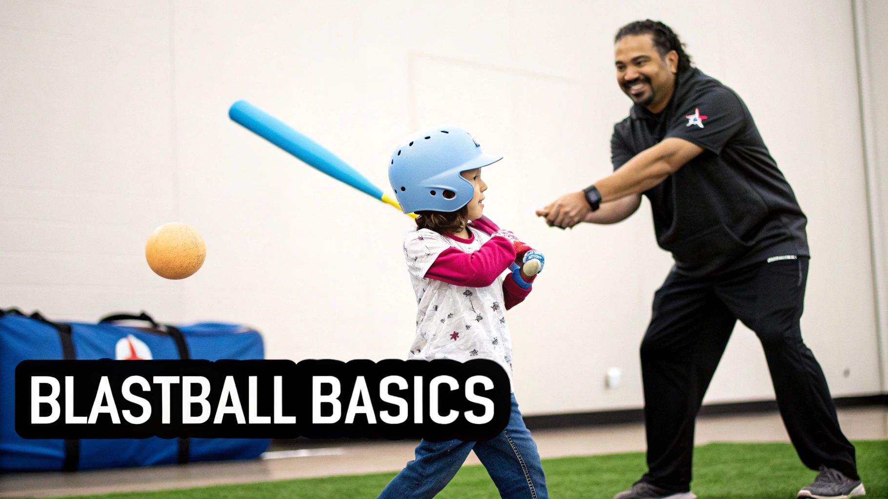 A young child in a blue helmet practicing blastball with a blue bat, assisted by an adult coach.