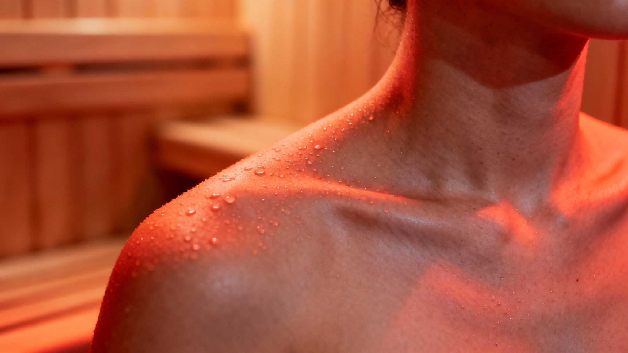 A person relaxing inside a modern infrared sauna, showcasing the detoxification benefits of infrared saunas.
