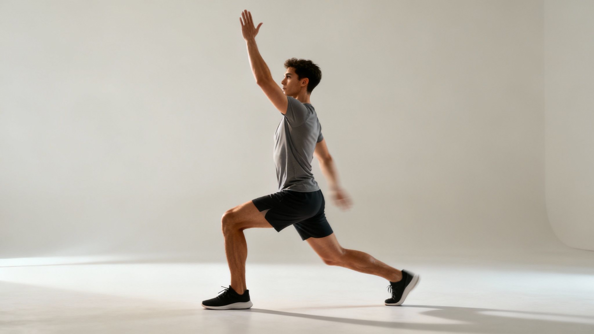 A woman performing a dynamic stretch with a resistance band in a gym setting.