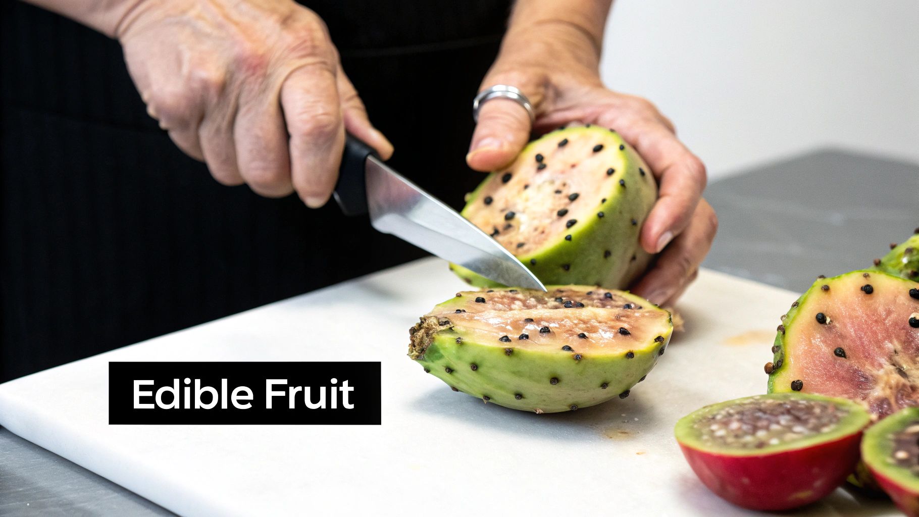 A ripe, red Peruvian Apple Cactus fruit sliced open to show its white flesh and black seeds.