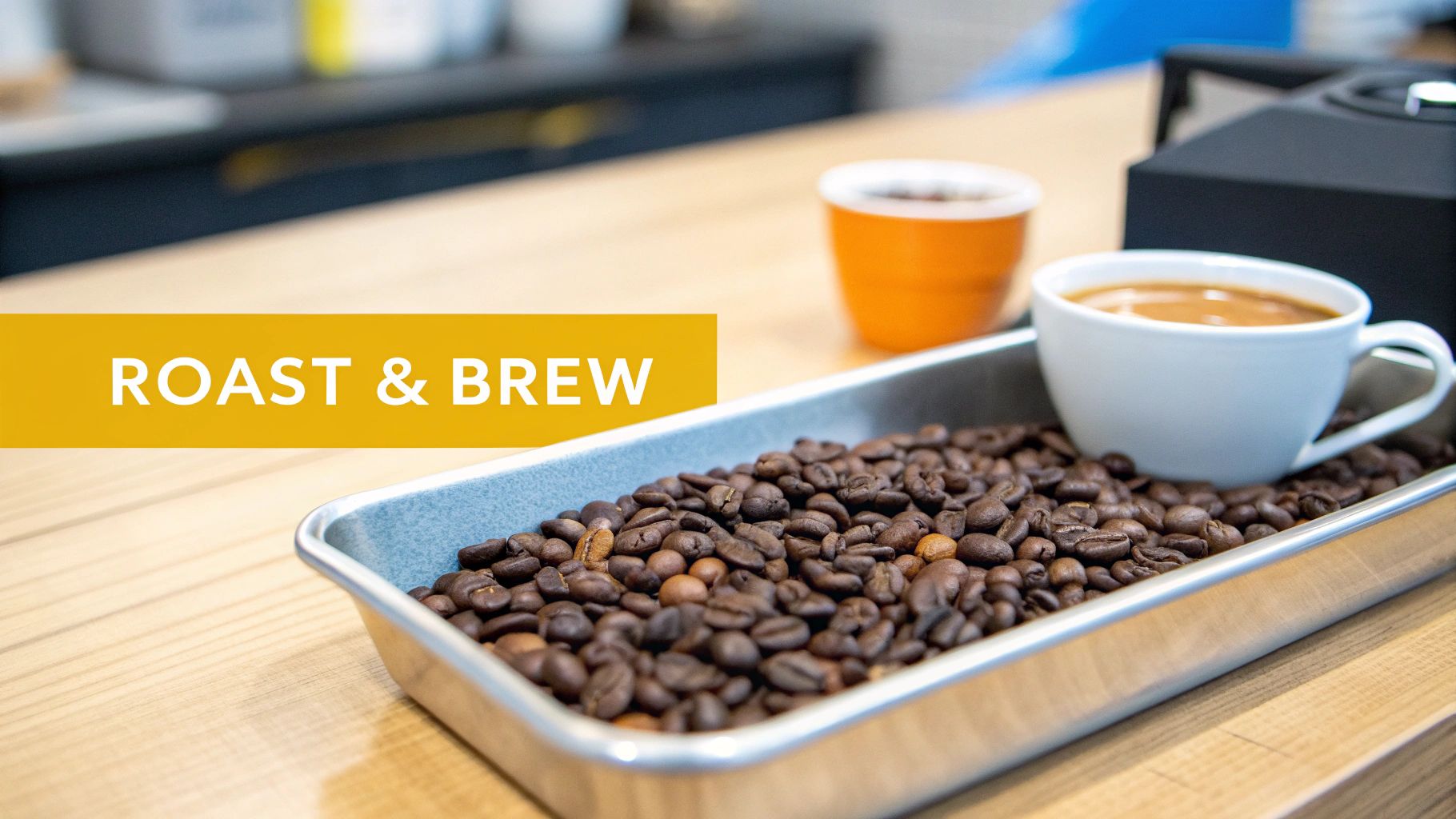 A close-up of dark roasted coffee beans in a metal tray with a white cup of brewed coffee, labeled 'ROAST & BREW'.
