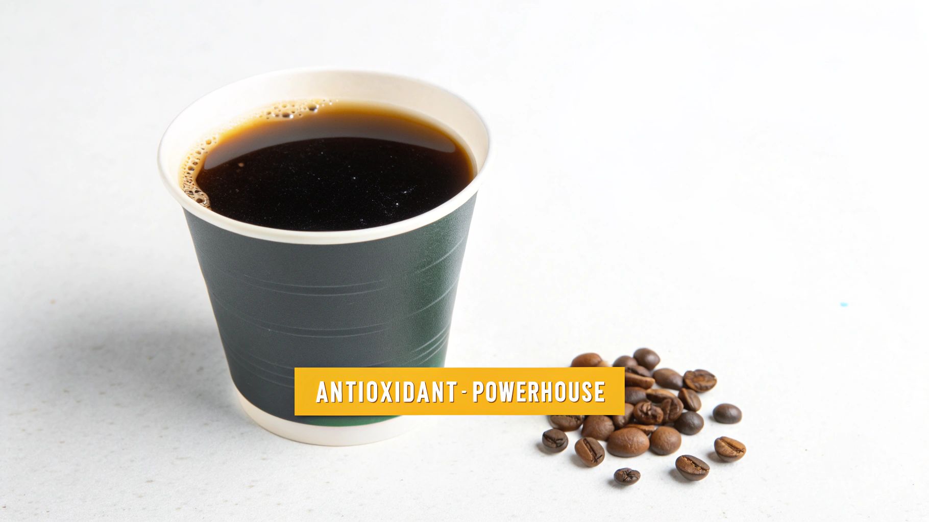 A black coffee in a dark green paper cup with roasted coffee beans and "ANTIOXIDANT - POWERHOUSE" text.
