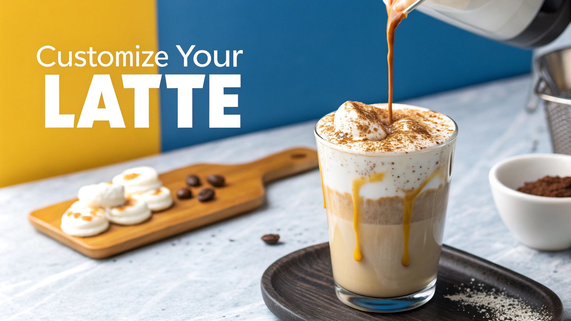 A person pouring frothed milk into a coffee base to create a latte, with drizzled syrup on top.