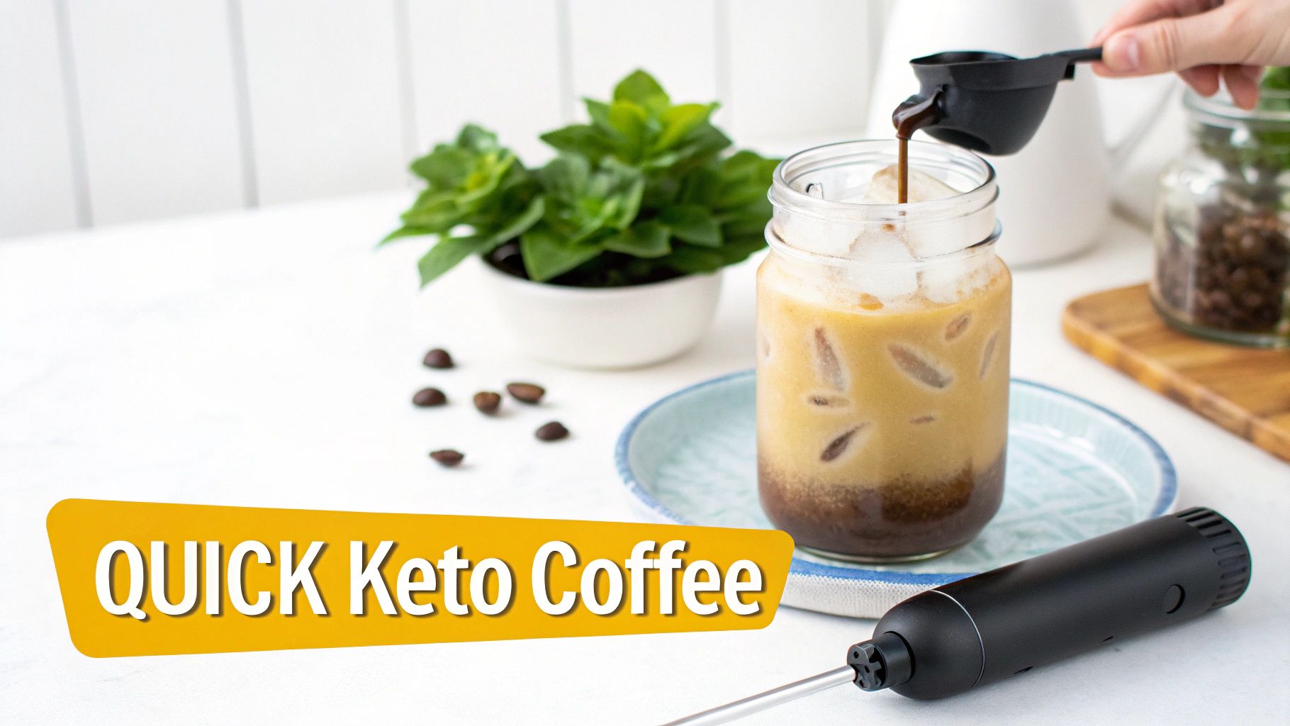A hand pours liquid into a glass of iced quick keto coffee, next to a frother and plant.