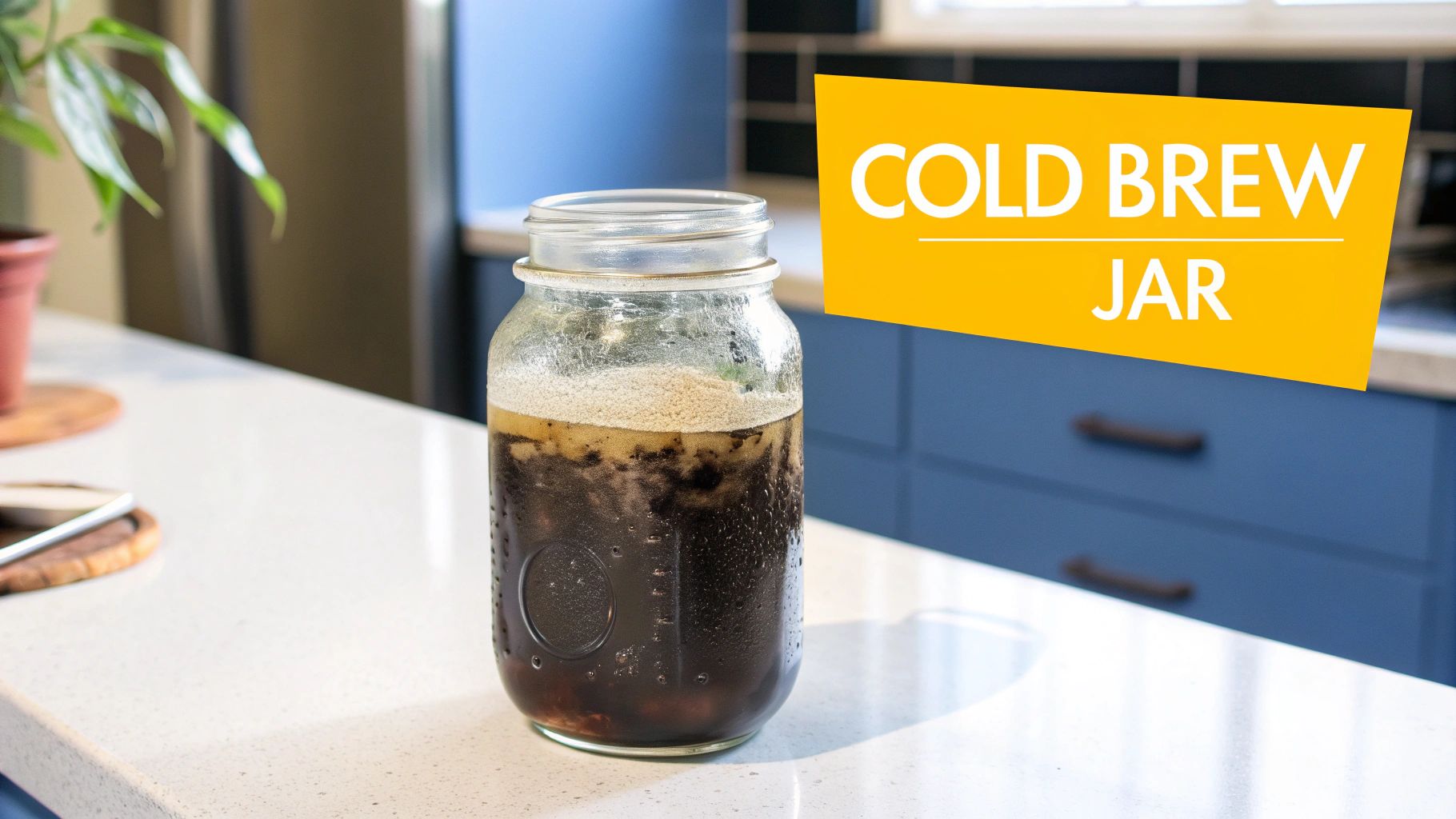 A glass jar of cold brew coffee steeping on a kitchen counter.