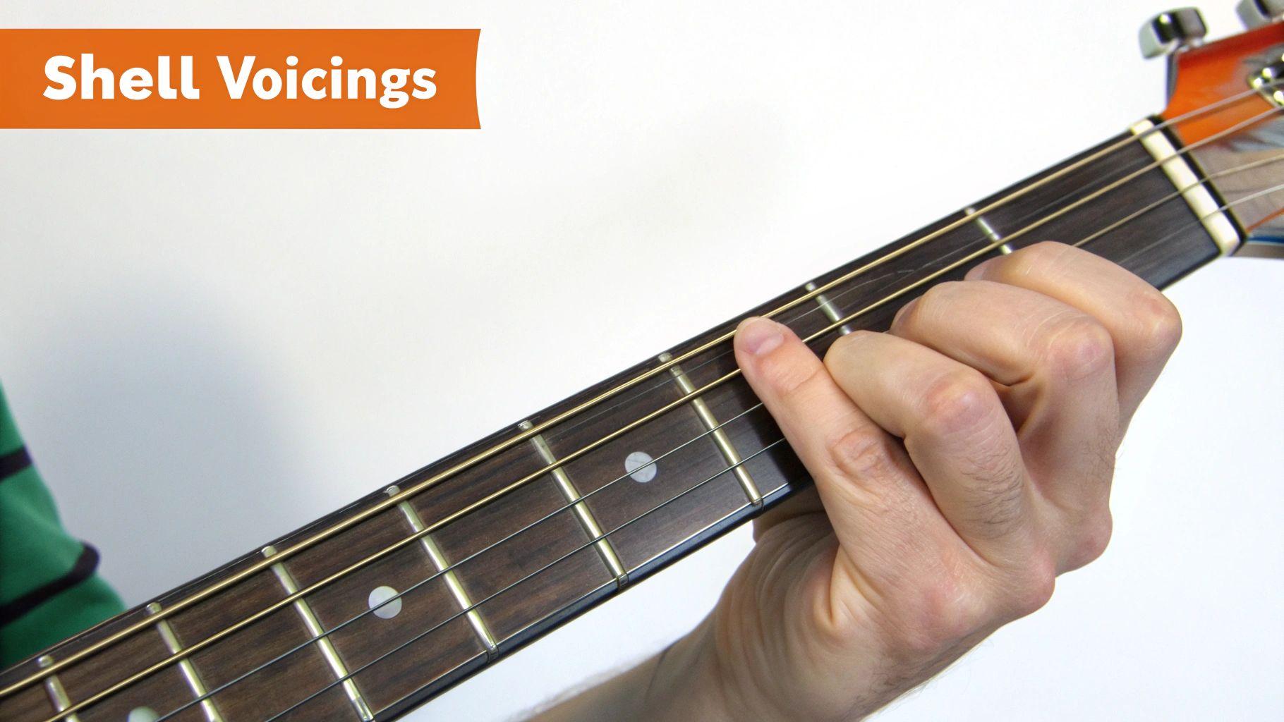 Close-up of a hand playing a guitar neck, demonstrating shell voicings on the fretboard.