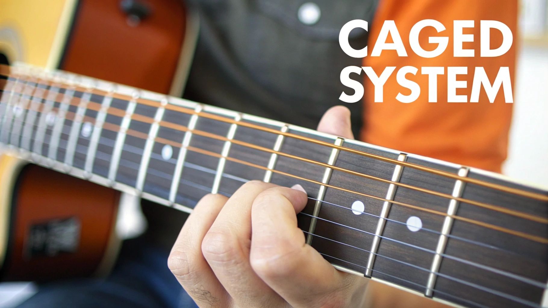 Close-up of a hand playing an acoustic guitar, illustrating the CAGED system on the fretboard.