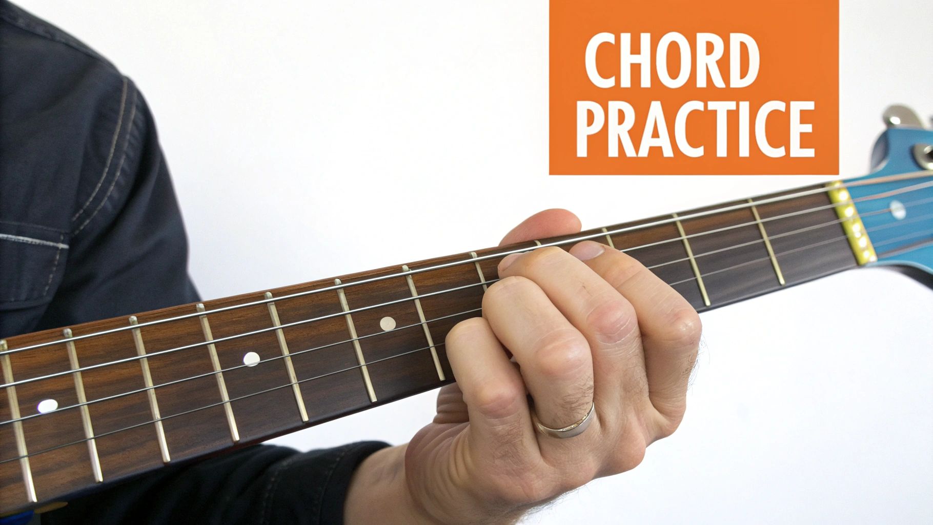 Close-up of a person's hand pressing down on an electric guitar fretboard, forming a chord.