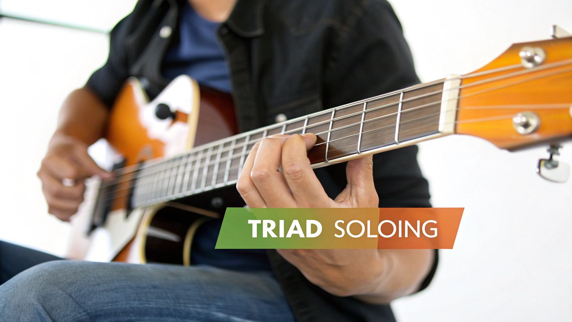Close-up of a person's hands playing an acoustic guitar on the fretboard, with 'Triad Soloing' text.