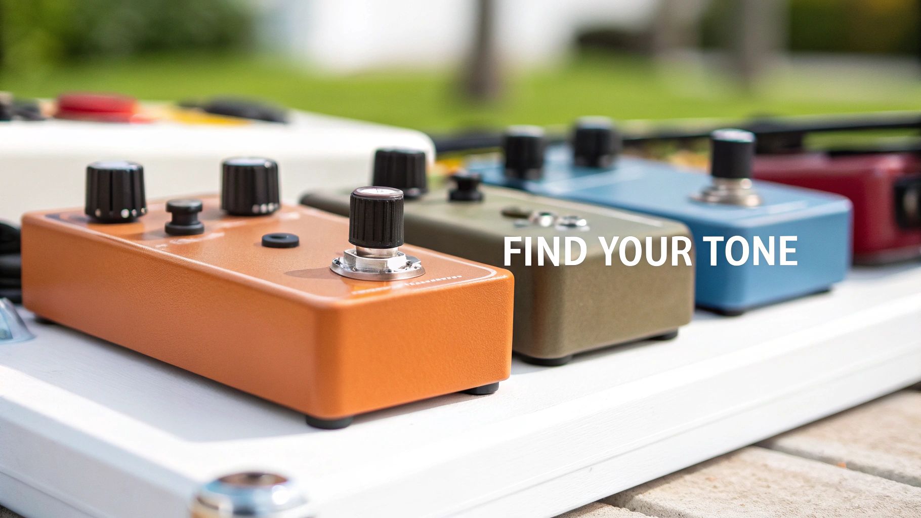 Colorful guitar effect pedals on a white pedalboard outdoors, with the motivational text 'FIND YOUR TONE' overlaid.
