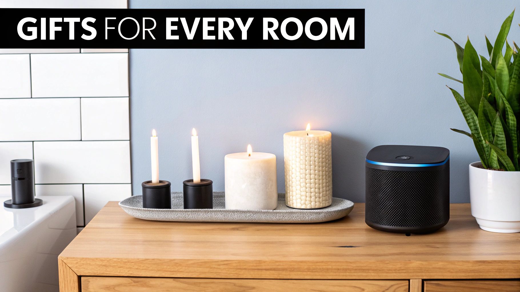Candles, a smart speaker, and a plant on a wooden counter, ideal home gifts.