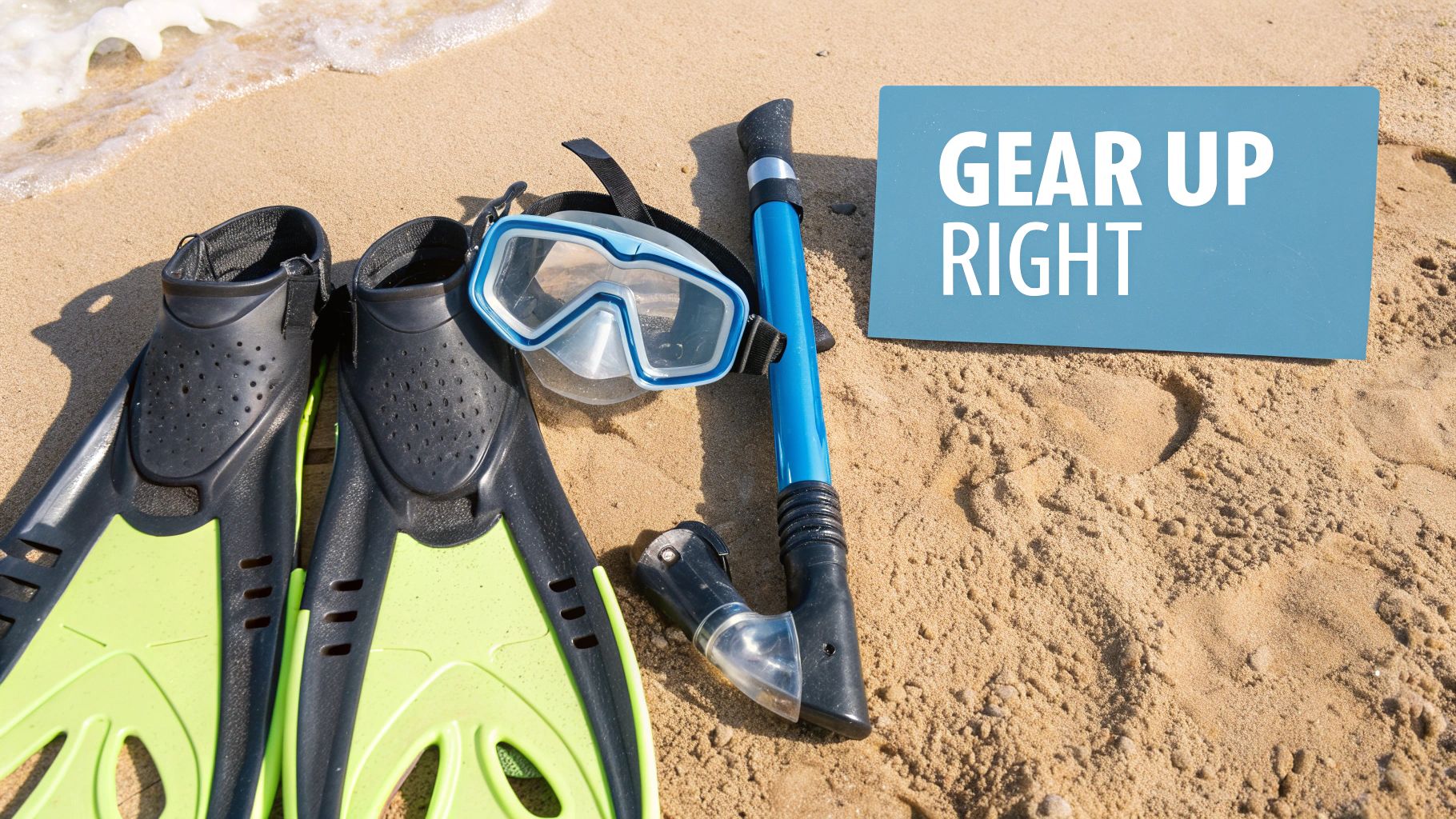 A collection of snorkeling gear, including a mask, snorkel, and fins, laid out on a wooden dock next to clear blue water.