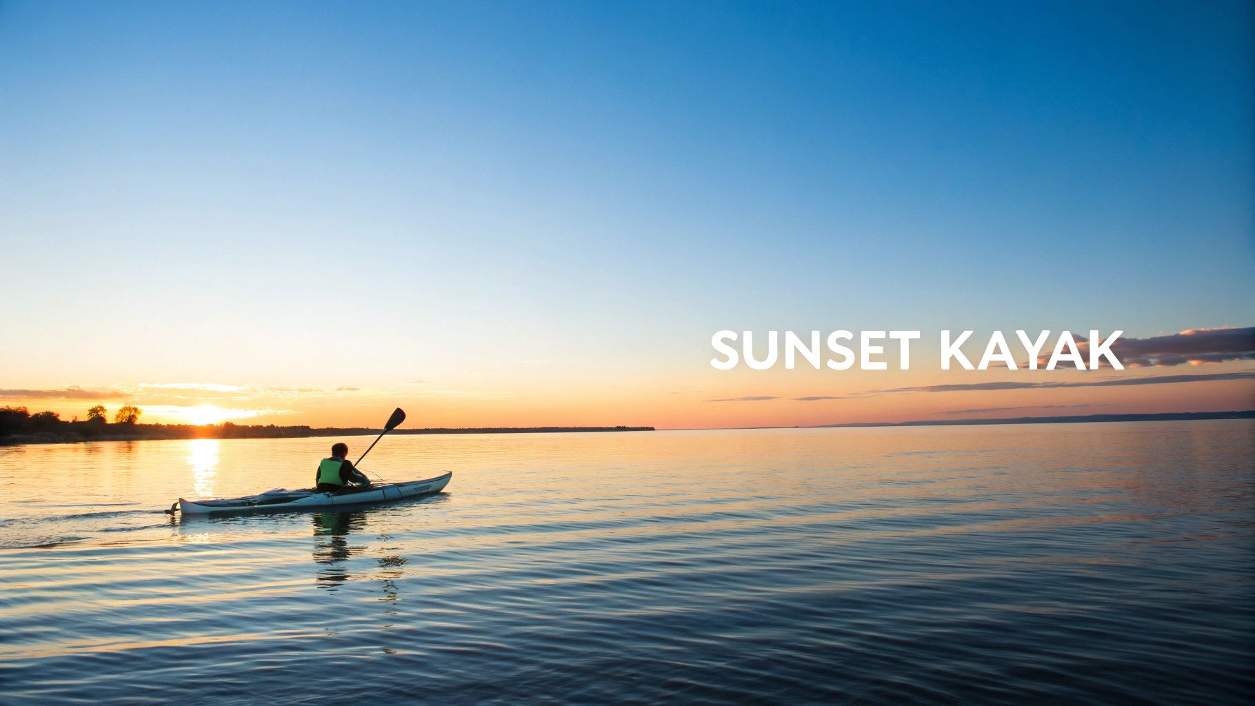 Person kayaking on calm water during golden sunset with paddle raised and clear blue sky
