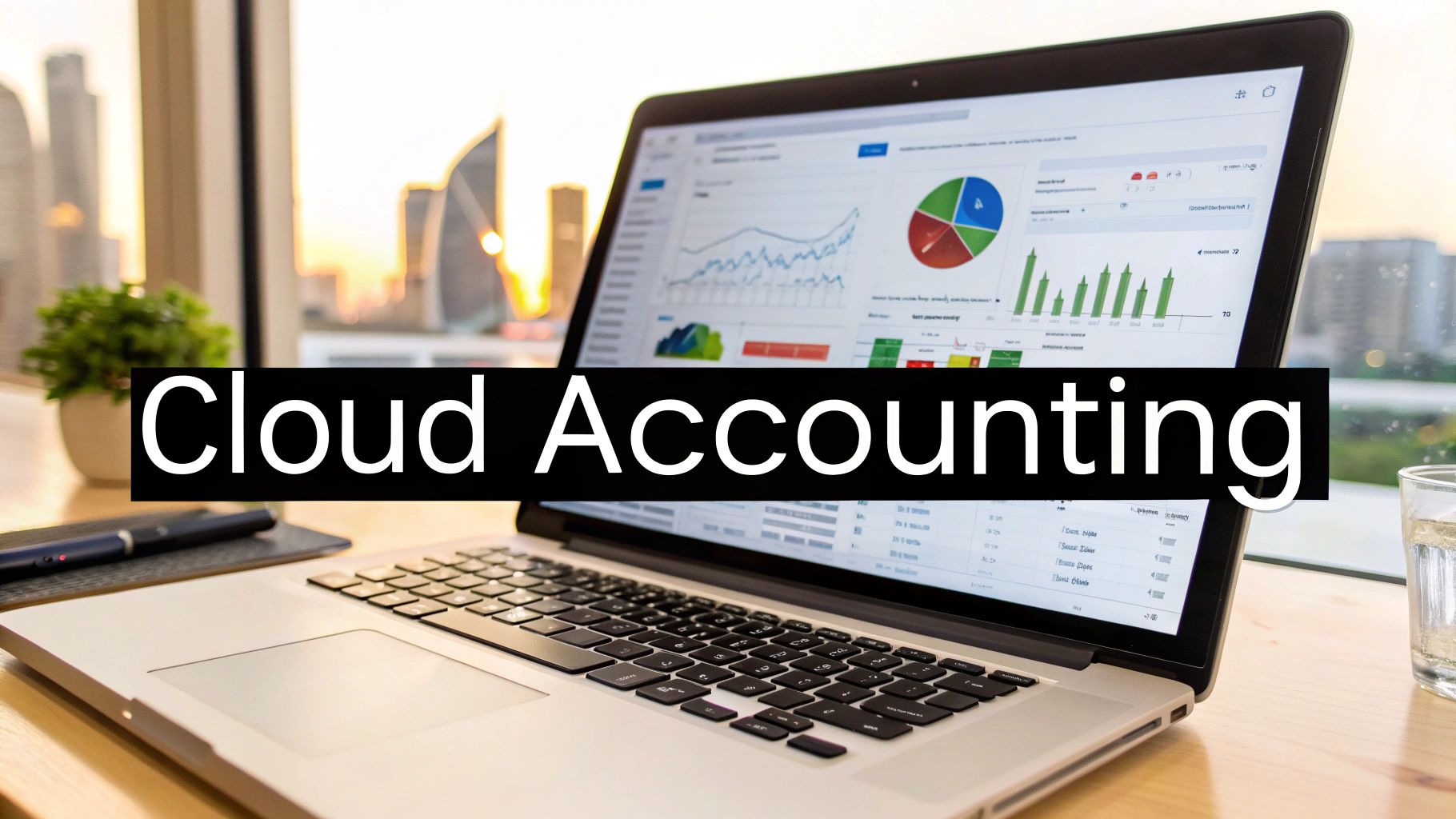 Laptop displaying cloud accounting software with charts and graphs, set against a sunset city view.