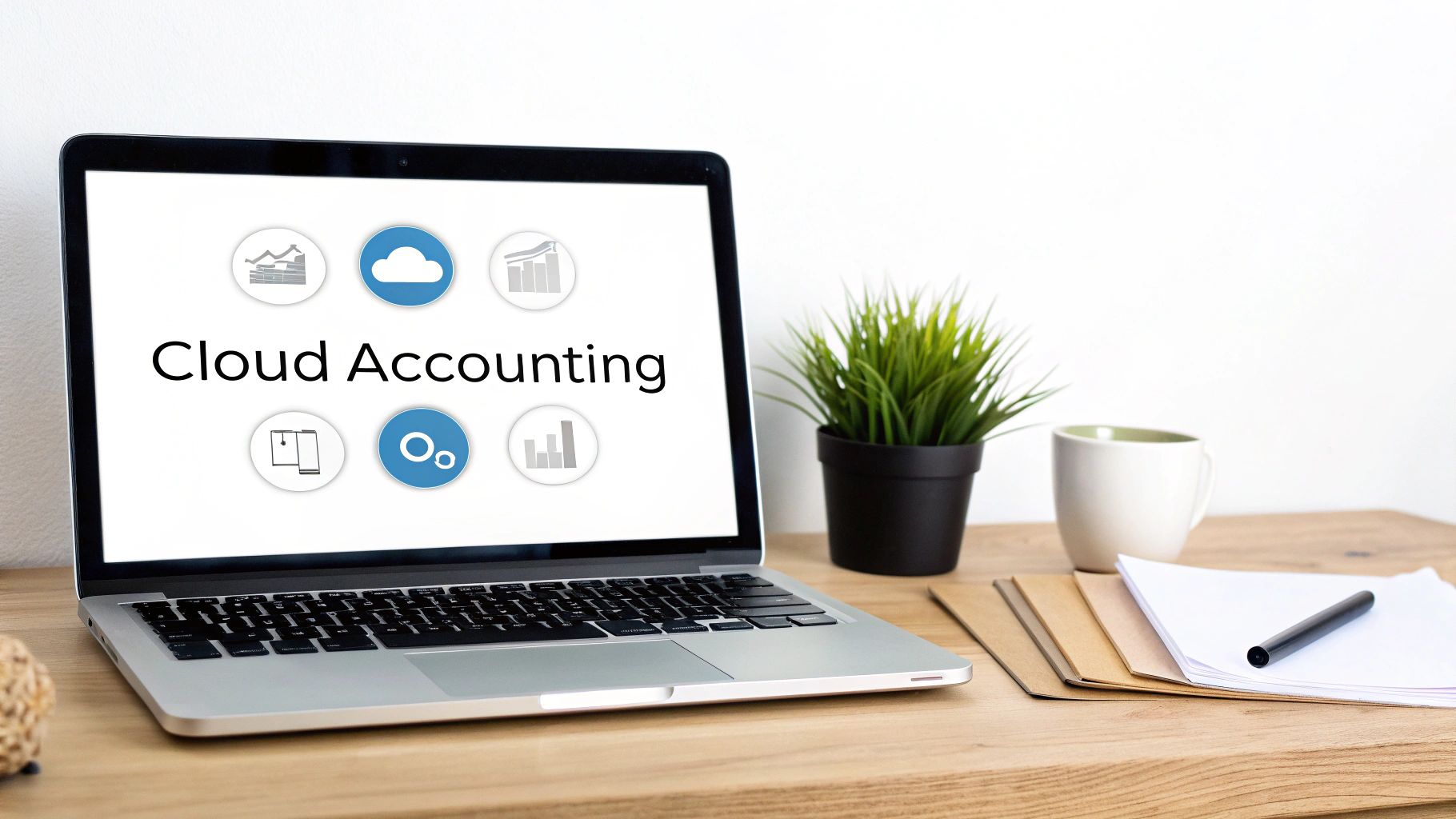 A laptop displaying 'Cloud Accounting' with icons, on a desk with a plant, mug, and documents.