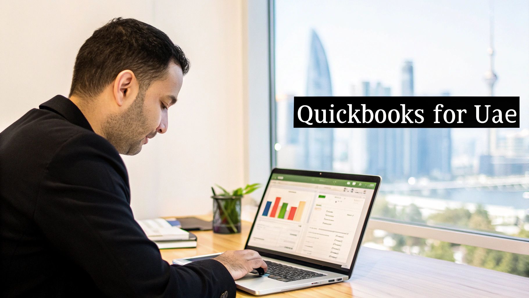 A man in a suit works on a laptop displaying business charts, with a city view. Text: Quickbooks for UAE.